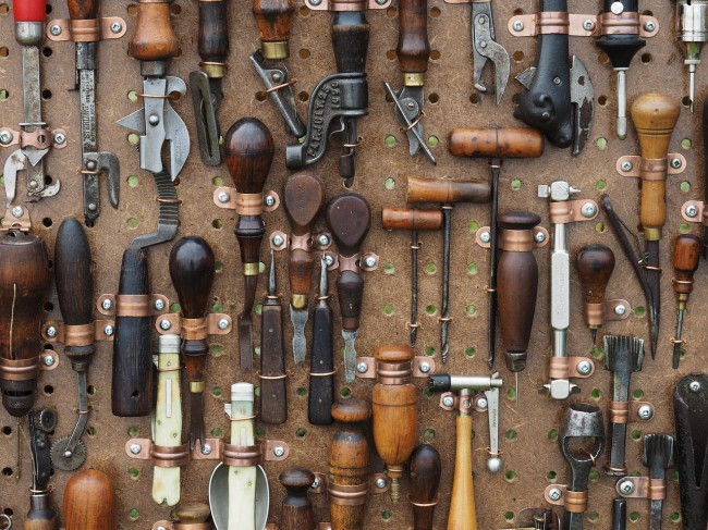 Many old hand tools on a wall